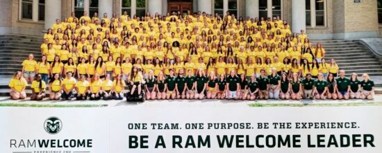 Large group of Ram Welcome leaders in matching yellow shirts on the steps of the CSU Administration building.